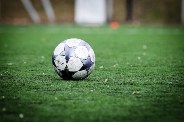 white and blue soccer ball on green grass field during daytime white and blue soccer ball on green grass field during daytime