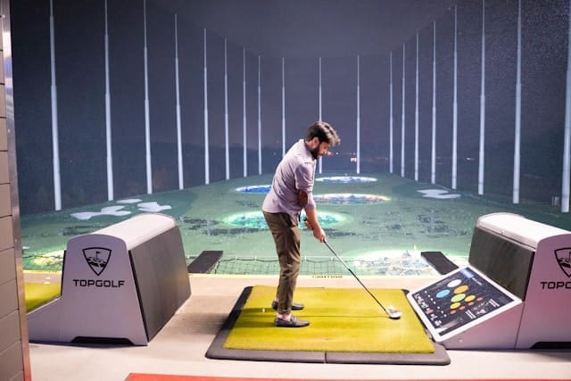 man playing top golf man playing top golf