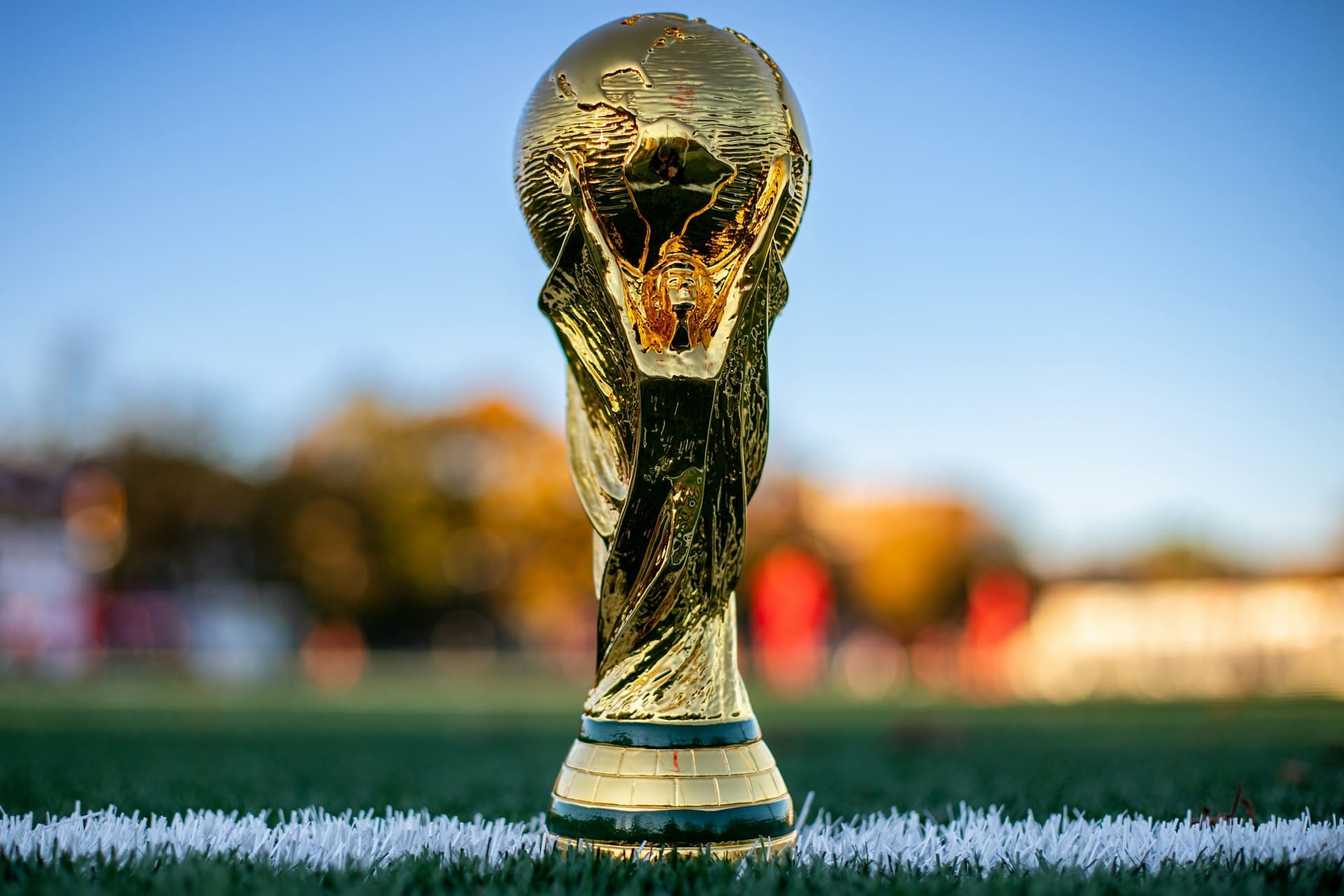 a soccer ball sitting on top of a golden trophy a soccer ball sitting on top of a golden trophy