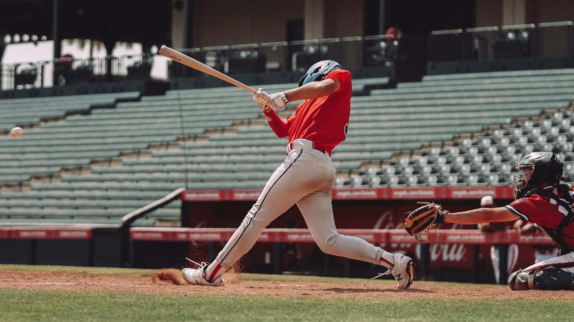woman in red jersey shirt and white shorts holding baseball bat woman in red jersey shirt and white shorts holding baseball bat