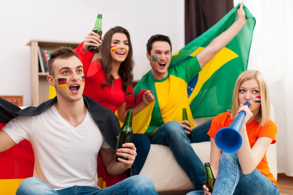 Multi ethnic group of people cheering football match Multi ethnic group of people cheering football match